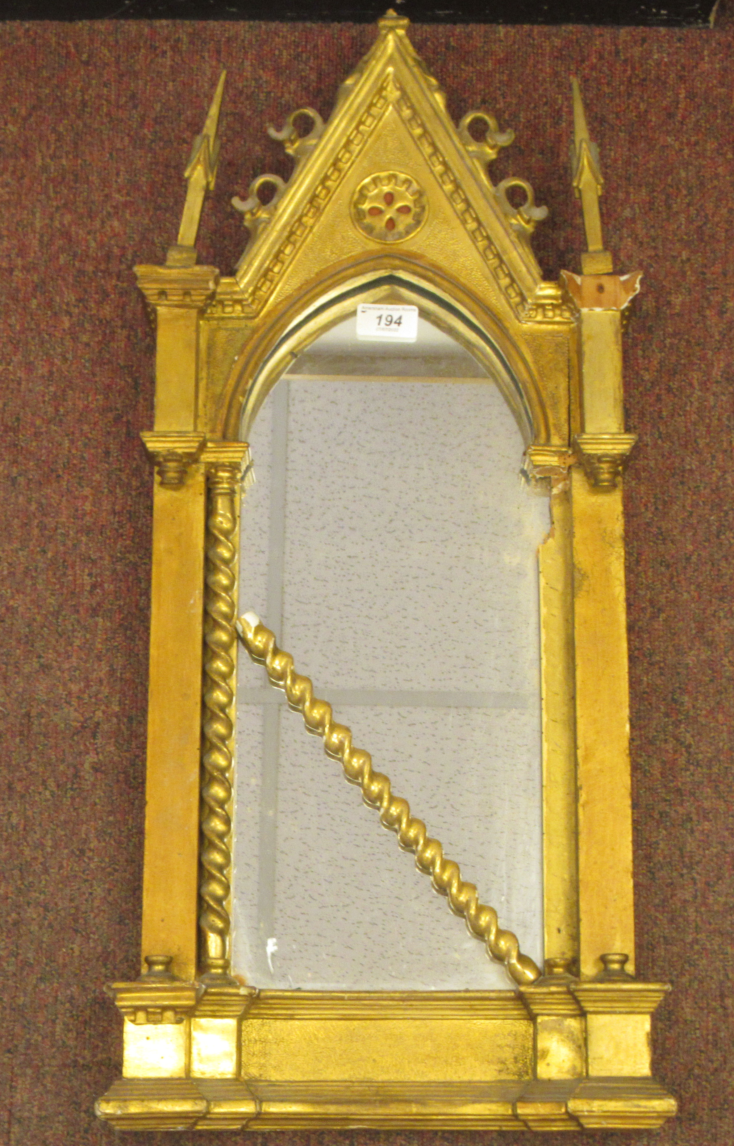 A 19thC Continental carved giltwood and gesso framed niche mirror of gothic design with a painted