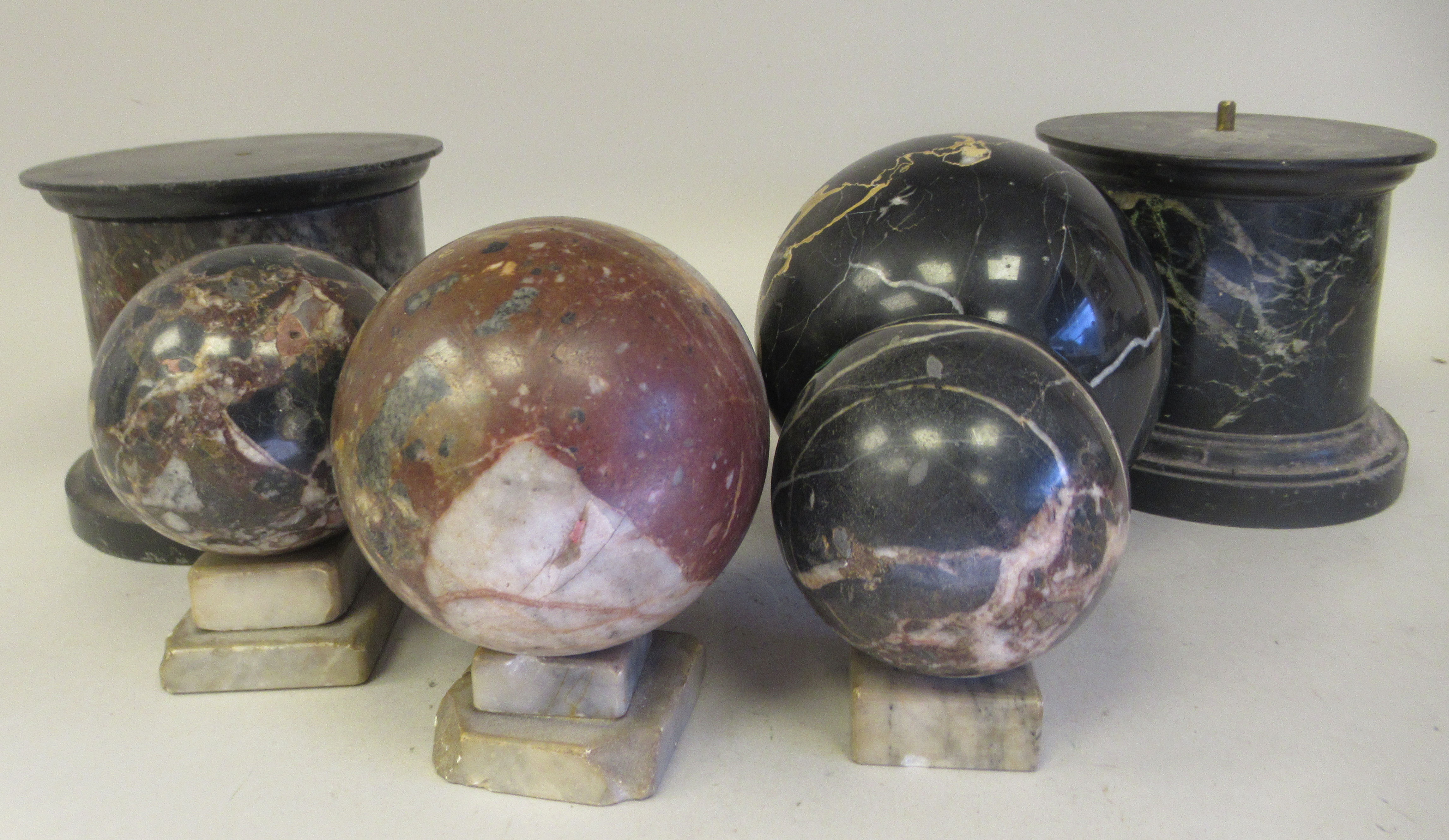 A late 19thC mottled multi-coloured turned marble ornaments, viz. a pair of drum design plinths  5"