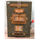 A vintage Lottomat 'one arm bandit' table-top/hanging fruit machine,in a speckled green and yellow
