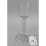 An 18th/19thC wine glass, the bucket shape bowl with engraved ornament, on a straight stem and