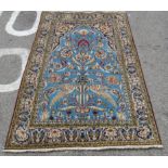 A Persian rug, decorated with exotic birds, flora and foliage, on a blue and multi-coloured