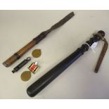 An early 20thC turned ebony police truncheon with a moulded grip and rivetted hide wriststrap  15"L;