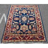 A Persian rug, decorated with stylised floral designs on a multi-coloured ground  59" x 74"