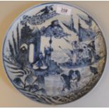 A 19thC Chinese porcelain dish in underglazed blue and white with figures engaged in fishing and