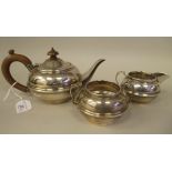 A bachelors three piece silver tea set of bulbous form  comprising a teapot with a swept spout, a
