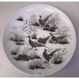 A Royal Copenhagen porcelain aluminia faience charger, decorated by Nils Thorsson with pheasants