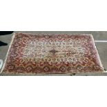 A Persian design rug with dense floral motifs on a beige ground   124" x 20"
