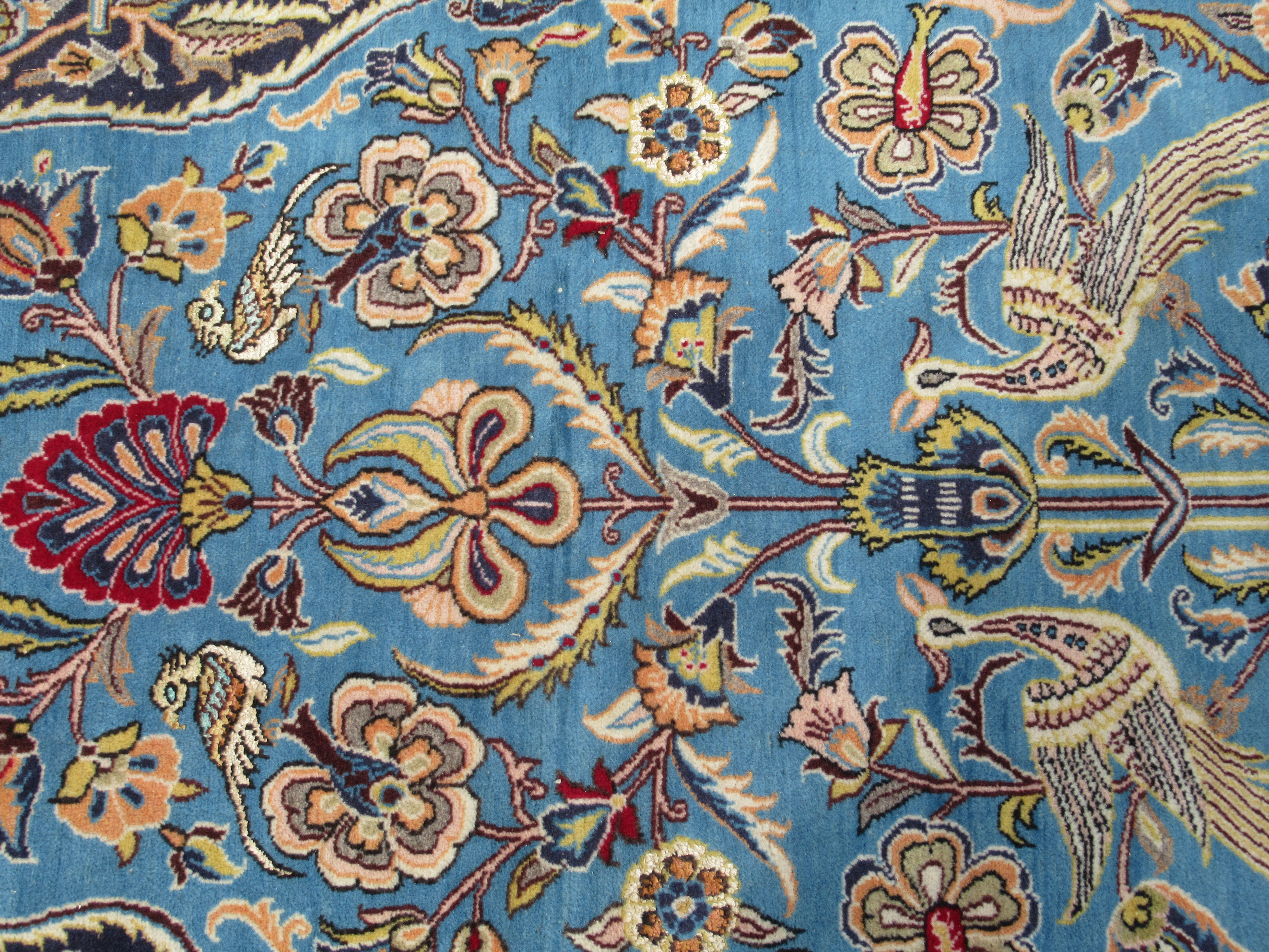 A Persian rug, decorated with exotic birds, flora and foliage, on a blue and multi-coloured - Bild 4 aus 5