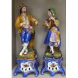 A pair of late 19thC Continental porcelain figures, a girl playing a mandolin and a man with