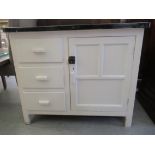 A 1950s white painted kitchen cabinet with an enamelled steel top, over a door and three drawers,