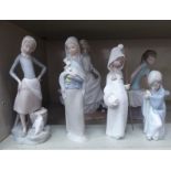 Six Lladro porcelain figures: to include a seated ballet dancer  9"h; and a girl walking with a