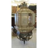 A late 19th/early 20thC Middle Eastern pendant lantern of square outline with multiple panes and a