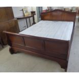 A modern mahogany framed sleigh bed, the headboard 66"w with a Sealy Aspen Posturepedic mattress