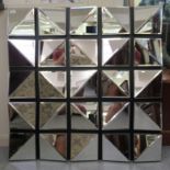 A modern mirror, made up of twenty-five pairs of angled bevelled panels, laid on board  39"sq