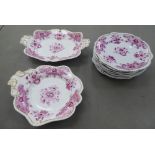 A late 19thC nine piece china dessert service, decorated in puce and gilding with Chinese inspired