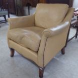 A modern fireside chair with a low, level back and enclosed scrolled arms, upholstered in studded,