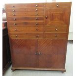 A 20thC mahogany dentists cabinet with an arrangement of drawers and cupboards, raised on bracket