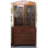 A George III satinwood and marquetry inlaid secretaire cabinet-on-chest with two astragal glazed