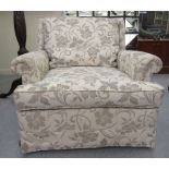 A modern floral fabric upholstered armchair, on casters