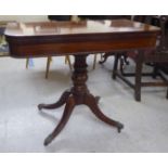 An early 19thC crossbanded rosewood and mahogany card table, the foldover top raised on a turned,