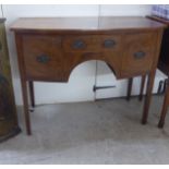 A Regency mahogany sideboard with a central drawer, flanked by two cellarette drawers, raised on