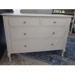 A Laura Ashley white painted four drawer dressing chest, raised on tapered legs  32"h  42"w