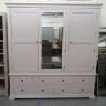 A Cotswold Company white painted wardrobe with a central mirrored back, flanked by a pair of