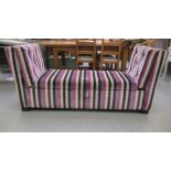 A modern multi-coloured striped pattern fabric covered window seat  70"w with a cushioned, hinged