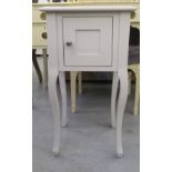 A Laura Ashley white painted bedside chest with a panelled door, raised on cabriole legs  26"h  15"w