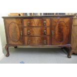 A 1930s mahogany bow front sideboard with a central bank of three drawers, flanked by a pair of