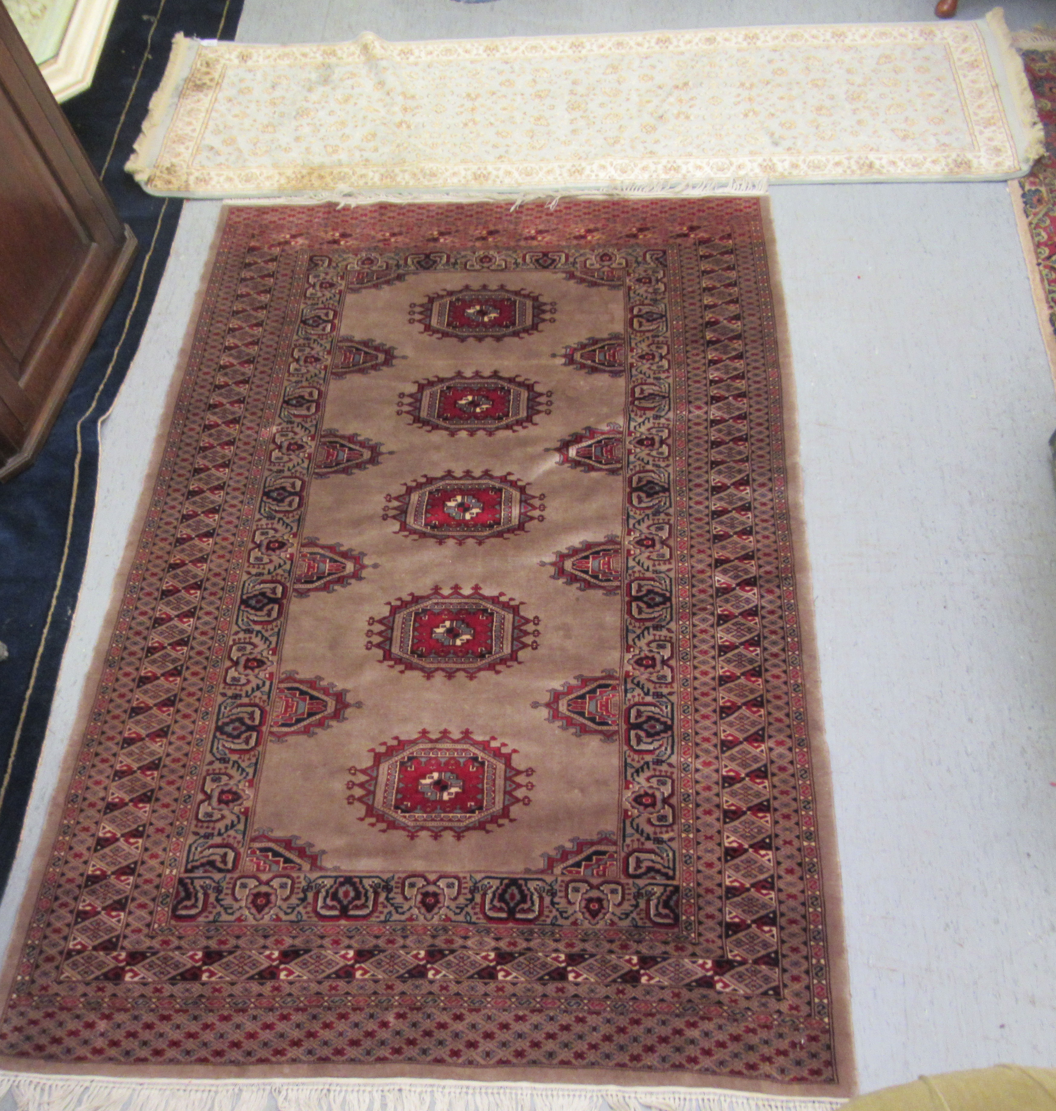 A Bokhara rug, on a multi-coloured ground  52" x 82"; and a machine made Baluchi runner  26" x 84"