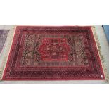 A Persian part silk prayer rug, decorated with repeating stylised designs, on a red ground  52" x