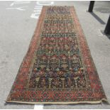 A Persian runner, profusely decorated with repeating stylised designs, on a multi-coloured ground