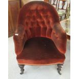 An early 20thC part button brown fabric upholstered nursing chair, raised on turned forelegs and