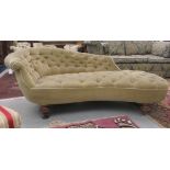 An Edwardian chaise longue, later upholstered in green fabric, raised on turned feet