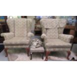 A pair of modern high wingback armchairs, upholstered in patterned pastel coloured fabric with