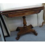 A Regency mahogany card table, the rotating foldover top raised on a baluster column and splayed