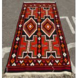 A Kelim rug with geometric motifs, on a multi-coloured ground  52" x 104"