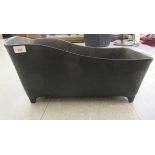 A black painted, cast iron farmyard feeding trough with opposing handles  9"h max  23"w