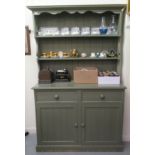 A 20thC green painted pine dresser, the superstructure with two open plate shelves, over two