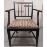 A George III mahogany framed elbow chair, the later tapestry fabric covered seat raised on square,