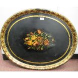 A late 19thC black lacquered papier mache oval tray, decorated with a mixed floral bouquet and a