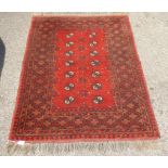 A Bokhara rug with elephant foot pattern motifs, on a terracotta ground  41" x 62"