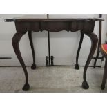 An early 20thC mahogany table, the serpentine outlined top raised on cabriole legs, talon and ball