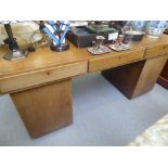 An Art Deco mahogany, twin pedestal, three drawer, banker's desk with a satinwood lined interior and