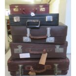Five items of 20thC hide and other luggage and briefcases  largest 7"h  24"w