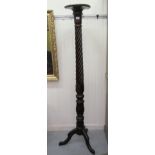 A mid 20thC wrythen carved and turned mahogany torchere with a plate top, raised on a cabriole