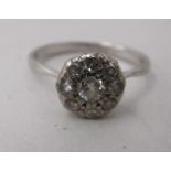 A white metal floral design diamond set cluster ring