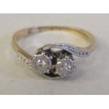 A 9ct gold two stone diamond set crossover ring