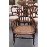 A late 19th/early 20thC, probably American maple framed chair, the high back and enclosed arms